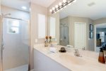 The master bathroom shower features dual sinks and a walk in shower